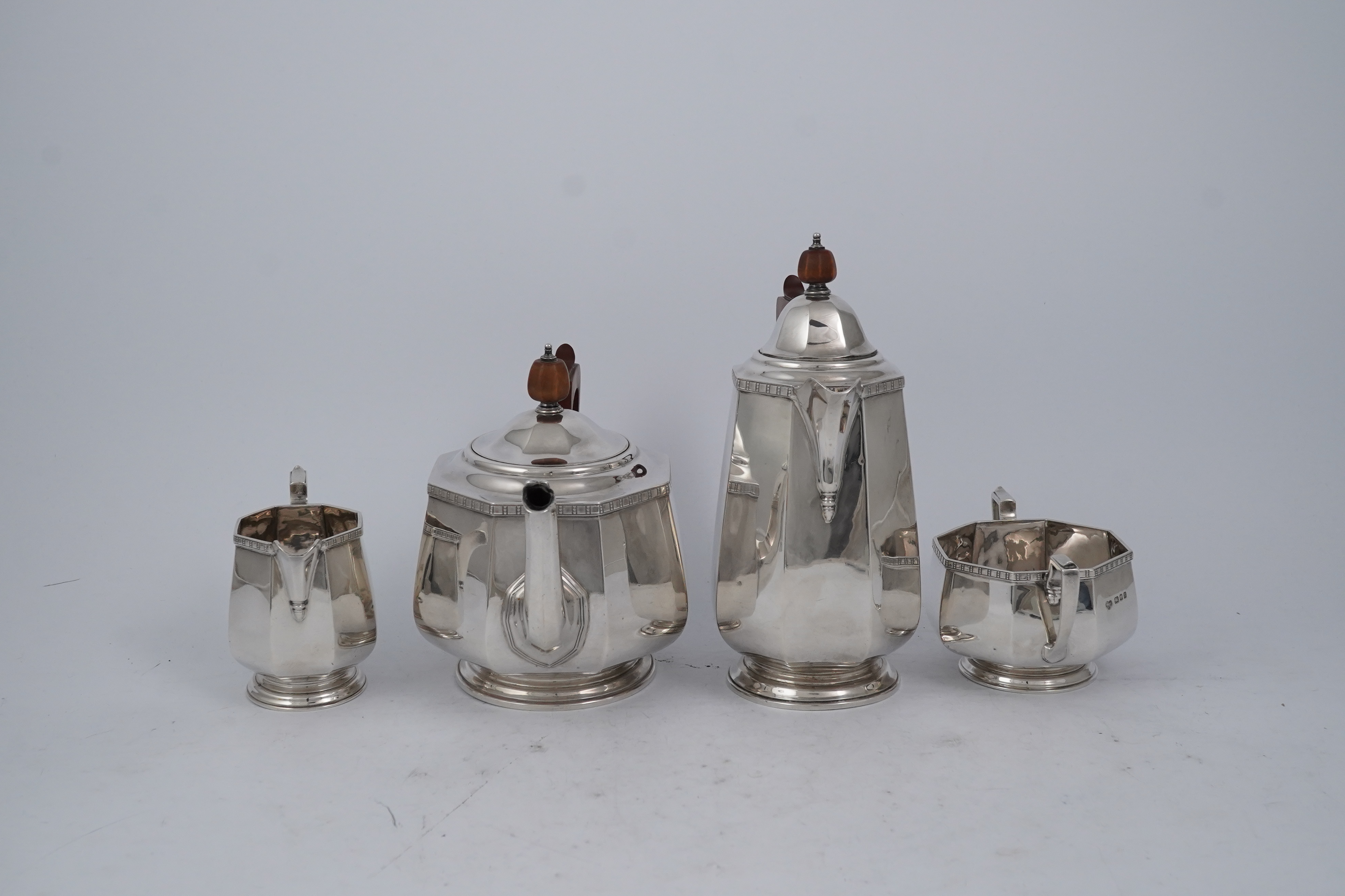 A George V silver four piece octagonal tea set by Goldsmiths & Silversmiths Co Ltd